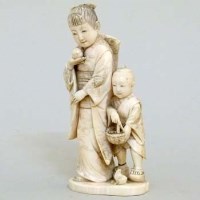 Lot 305 - Ivory figure of a lady and child.