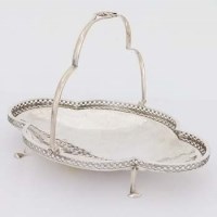 Lot 517 - Silver swing handled dish.