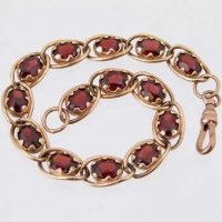 Lot 585 - 9ct gold garnet line bracelet.