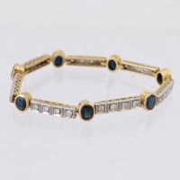 Lot 597 - 750 yellow and white gold sapphire and diamond