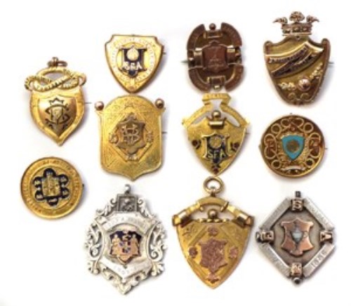 49 - Eleven Gold and Silver football medals awarded to Tom Clare