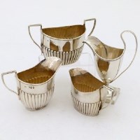 Lot 219 - Silver cream helmet, two half reeded milk jugs and a sugar basin.