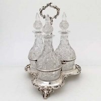 Lot 269 - Victorian silver three-bottle decanter stand.