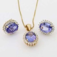 Lot 370 - Pair of tanzanite and diamond oval cluster