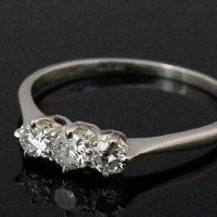 Lot 329 - Three-stone diamond platinum ring.