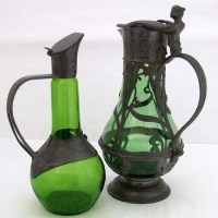 Lot 43 - Two pewter mounted claret jugs.