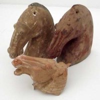 Lot 122 - Three horses's heads, Han and Tang dynasties