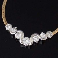 Lot 316 - 14k gold necklace with seven diamonds.