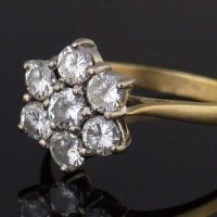 Lot 348 - Seven-stone diamond cluster ring.