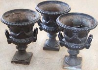 Lot 609 - Three cast iron neo classical canpana garden urns