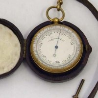 Lot 48 - Cased gilt metal barometer in leather case.