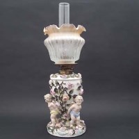 Lot 260 - Oil lamp modelled with three cherubs
