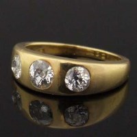 Lot 448 - 18ct gold three-stone diamond gypsy-set ring, old