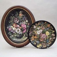 Lot 169 - Black ground oval plaque and a circular plaque by