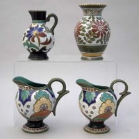 Lot 232 - Pair of gouda ewers and one other also a vase.