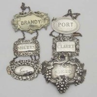 Lot 258 - Five silver and 1 E.P. wine labels.