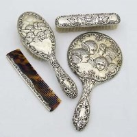 Lot 268 - Angel embossed silver dressing table set.