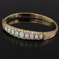 Lot 315 - 9ct gold opal and diamond bangle.