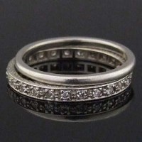 Lot 316 - Platinum and diamond full hoop eternity ring; a
