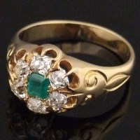 Lot 323 - Emerald and diamond cluster ring.