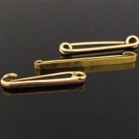 Lot 329 - Three gold tie pins.