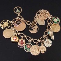 Lot 339 - 9ct gold charm bracelet with many charms, 43.5g