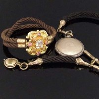 Lot 355 - Victorian fob watch chain and a gold bracelet both made of hair.