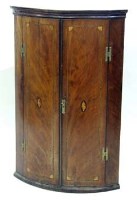 Lot 681 - Mahogany bow fronted wall hanging corner cupboard, early 19th Century