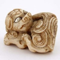 Lot 81 - Bone netsuke shishi.