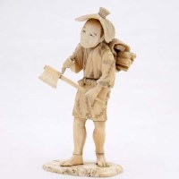 Lot 96 - Ivory figure of a man with bundle of sticks.