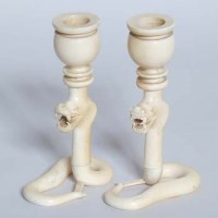 Lot 562 - Ivory dragon candlesticks.