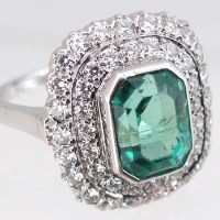 Lot 350 - 18ct gold emerald and diamond cluster ring, the