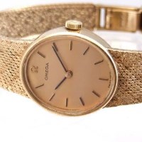 Lot 365 - Omega 9ct gold lady's wristwatch on integral