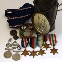 Lot 417 - Cased respirator together with assortment of various second world war medals and cap badges