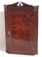 Lot 658 - George III mahogany corner cupboard