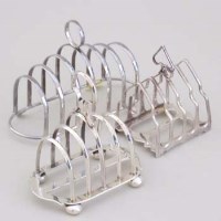 Lot 246 - Three silver toast racks