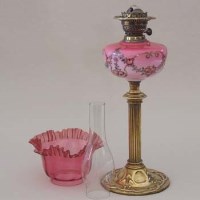 Lot 447 - Art Nouveau brass and cranberry glass oil lamp