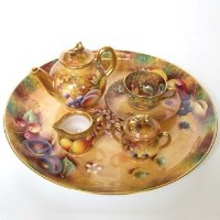 Lot 576 - Royal Worcester black mark miniature tea for one on tray.