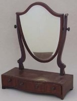 Lot 668 - Mahogany shield shaped toilet mirror.