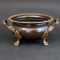 Lot 343 - Copper twin handled bowl on animal paw feet