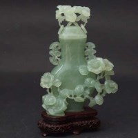 Lot 403 - Green jade vase and cover, 20th century.