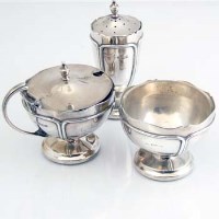 Lot 211 - Silver three piece cruet set.