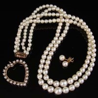 Lot 266 - Two strings of cultured pearls, a gold