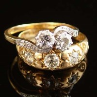 Lot 297 - Three stone diamond ring and a cross over ring.