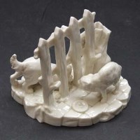 Lot 605 - Royal Worcester white glazed dog group.