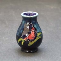 Lot 630 - Moorcroft miniature vase.