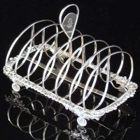 Lot 215 - Silver toast rack, IB London 1820, six divisions