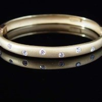 Lot 305 - Gold half-hoop bangle