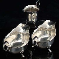 Lot 292 - Two silver sauce boats and a silver cream helmet