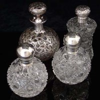 Lot 314 - Four silver topped scent bottles